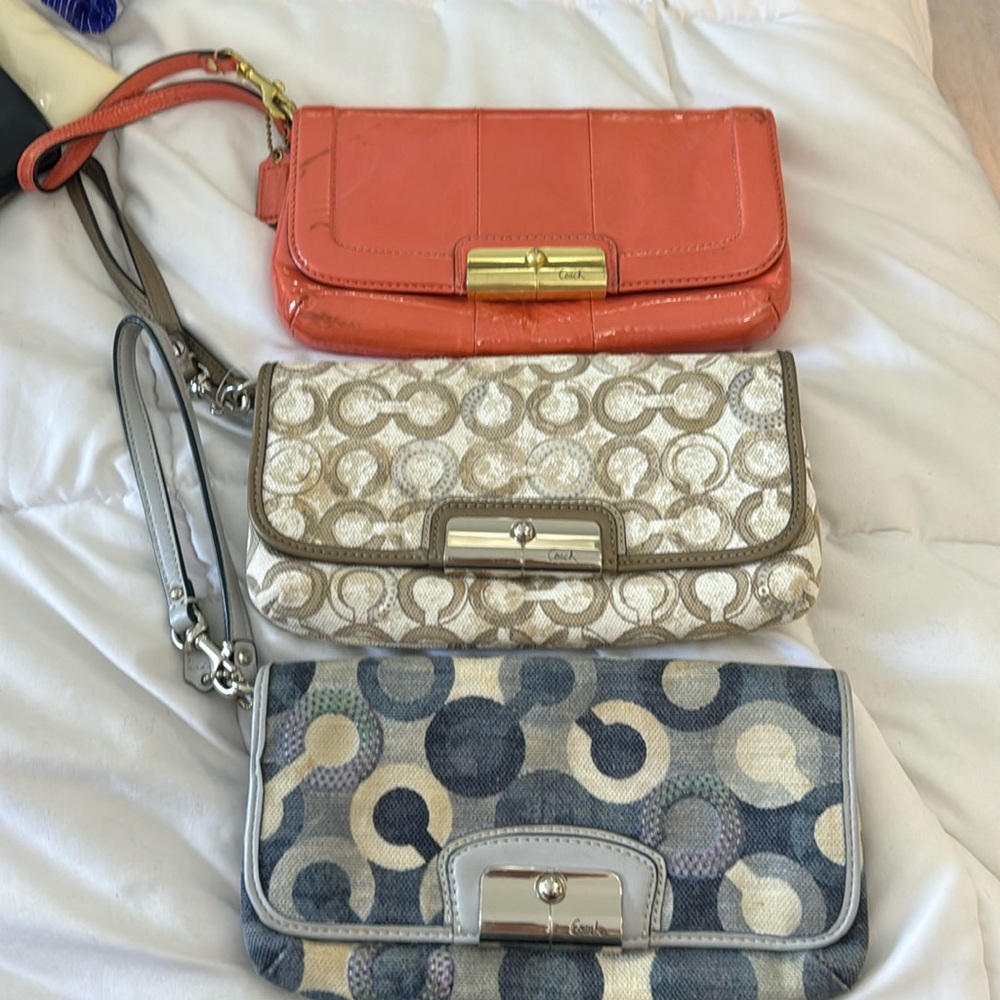Trip of coach wristlets.